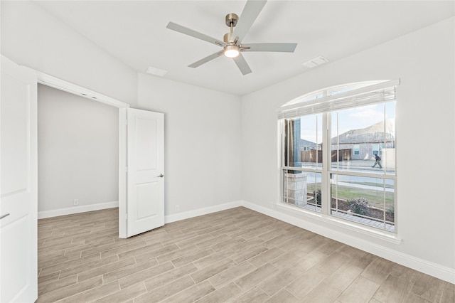 spare room with ceiling fan and a wealth of natural light