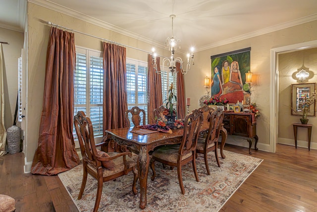 dining room with a chandelier, hardwood / wood-style flooring, and crown molding