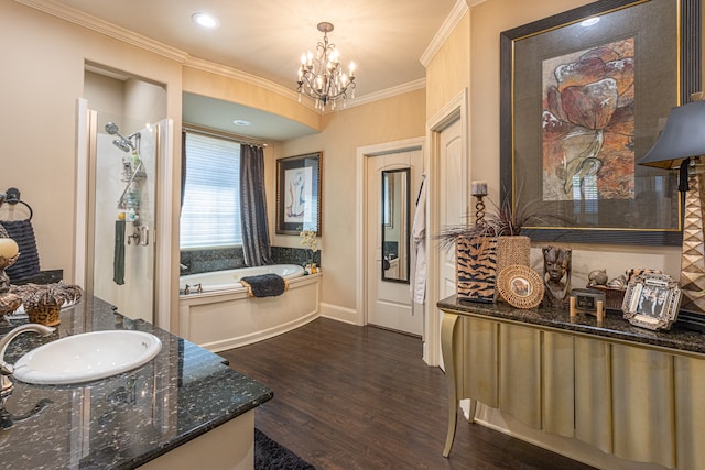 bathroom with vanity, crown molding, wood-type flooring, an inviting chandelier, and independent shower and bath