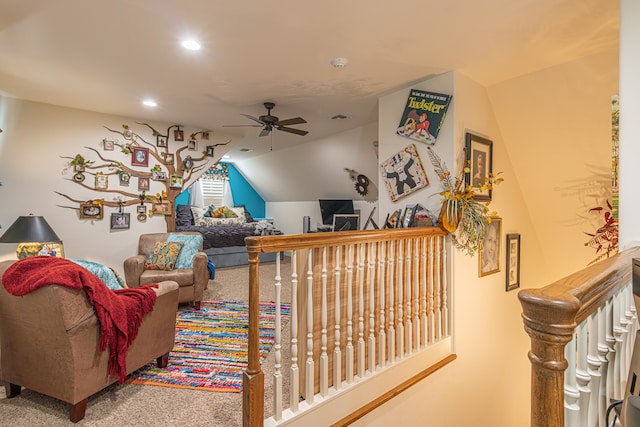 carpeted living room featuring ceiling fan and lofted ceiling