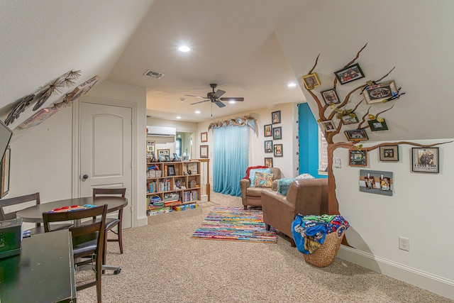 game room with ceiling fan, carpet floors, and a wall mounted air conditioner