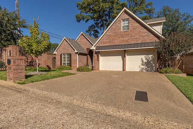 view of front property featuring a front lawn and a garage