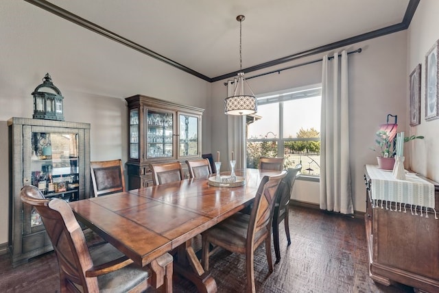 dining area featuring ornamental molding, dark wood-type flooring, and baseboards