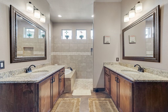 bathroom featuring tile patterned flooring, two vanities, and a sink