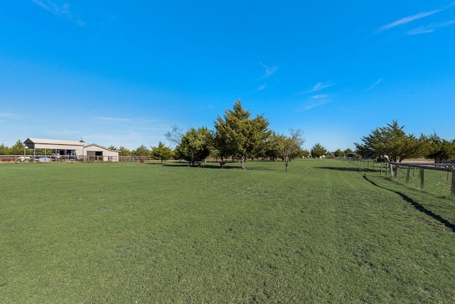 view of yard featuring a rural view and fence