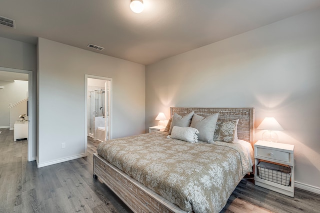 bedroom with hardwood / wood-style floors and ensuite bathroom