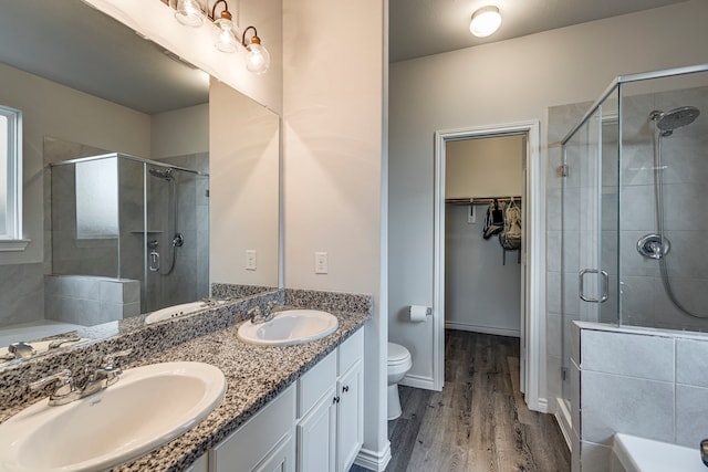 full bathroom with toilet, hardwood / wood-style floors, vanity, and shower with separate bathtub