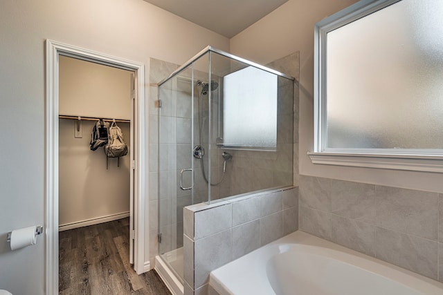 bathroom with plus walk in shower and hardwood / wood-style flooring