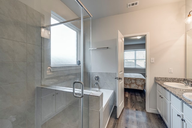 bathroom featuring wood-type flooring, vanity, and independent shower and bath