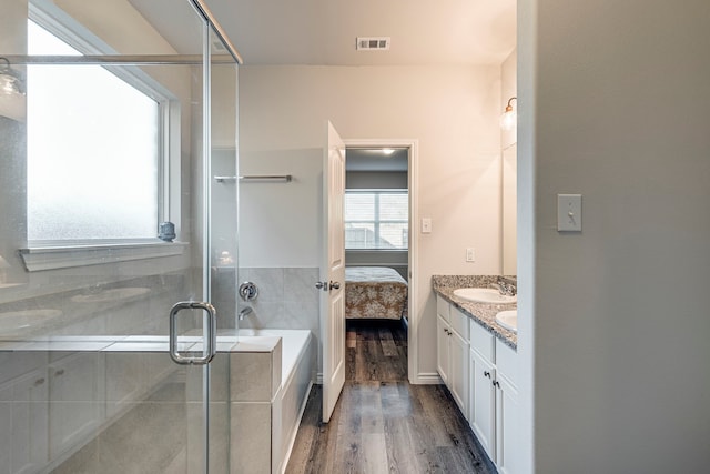 bathroom with shower with separate bathtub, wood-type flooring, and vanity