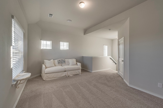 sitting room with lofted ceiling and light carpet