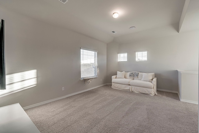 living area featuring light carpet and plenty of natural light