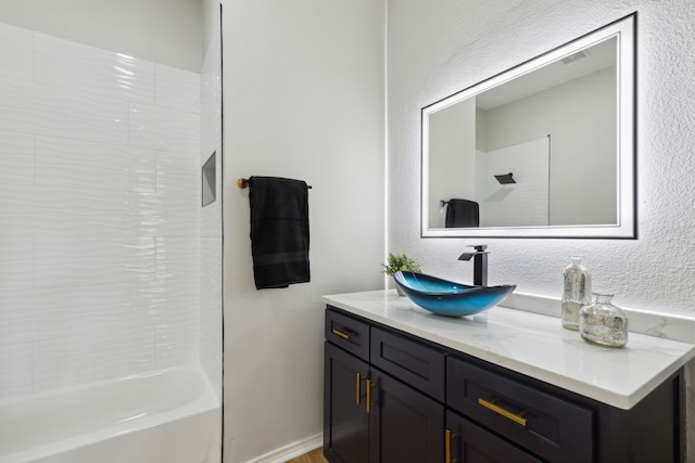 bathroom featuring vanity and shower / bathtub combination