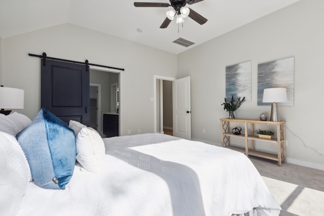 carpeted bedroom featuring a barn door, ceiling fan, lofted ceiling, and connected bathroom