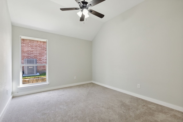 empty room featuring light carpet, vaulted ceiling, and ceiling fan