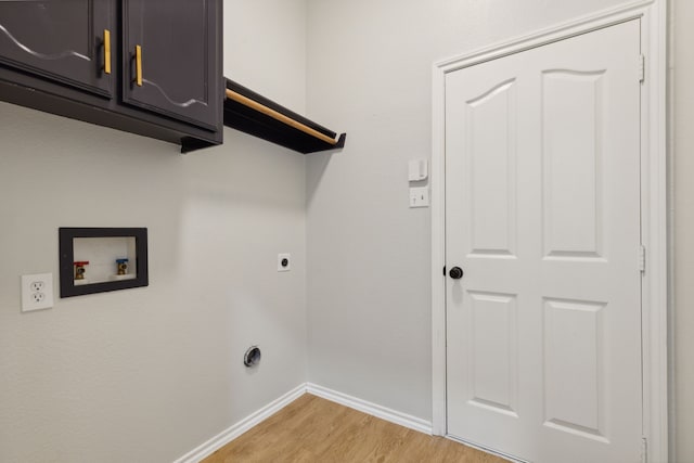 clothes washing area with electric dryer hookup, cabinets, light wood-type flooring, and hookup for a washing machine