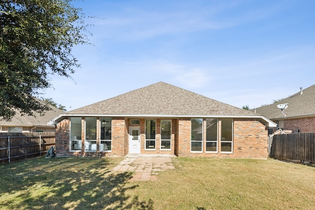 rear view of house with a yard