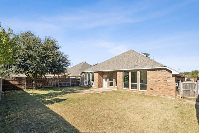 back of house with a lawn