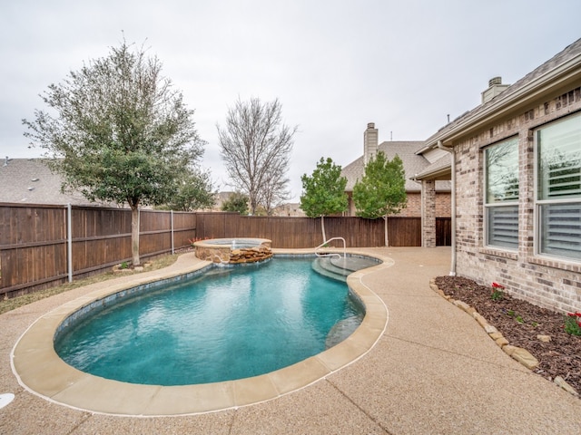 view of swimming pool with an in ground hot tub and a patio area