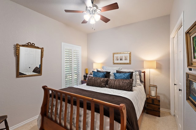 carpeted bedroom with ceiling fan and a closet