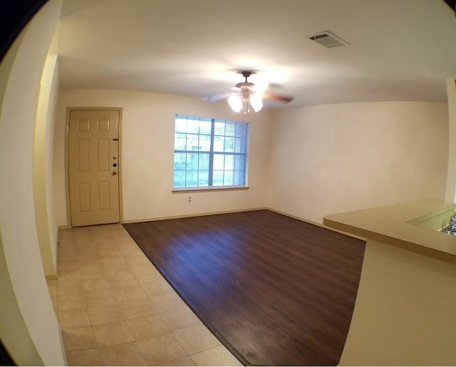 foyer entrance featuring ceiling fan and light wood-type flooring