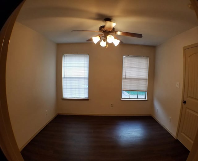 spare room with ceiling fan and dark hardwood / wood-style floors