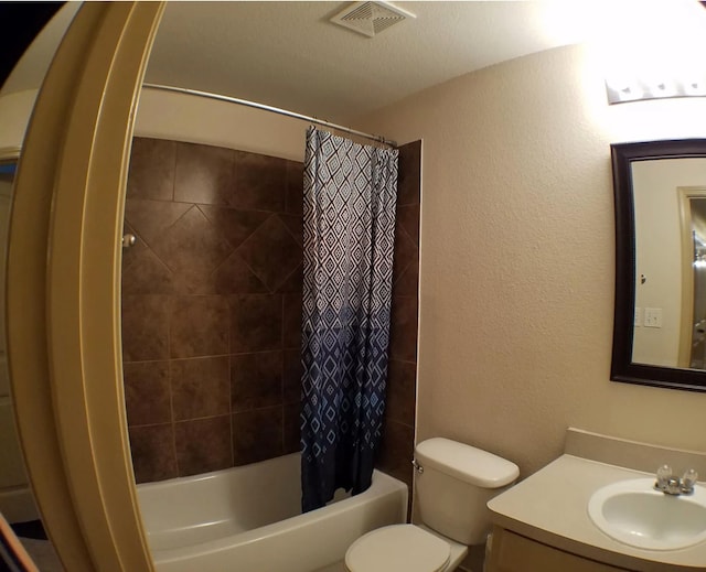 full bathroom featuring a textured ceiling, vanity, shower / tub combo, and toilet