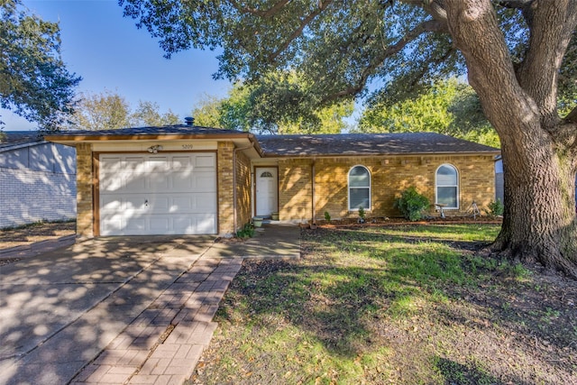 ranch-style home featuring a front yard and a garage