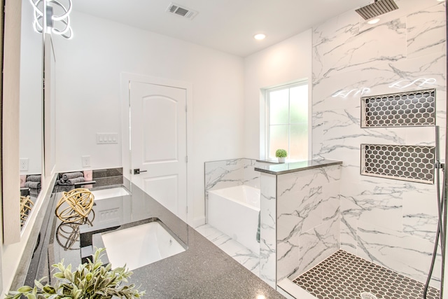 bathroom featuring vanity and shower with separate bathtub