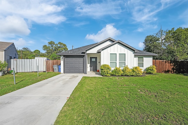 view of front facade with a front yard and a garage