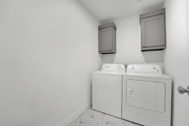 laundry area with cabinets, independent washer and dryer, and light tile patterned floors