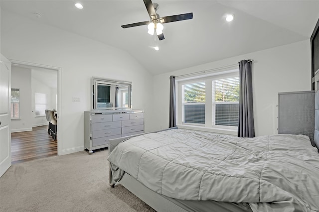 bedroom with vaulted ceiling, ceiling fan, and light carpet