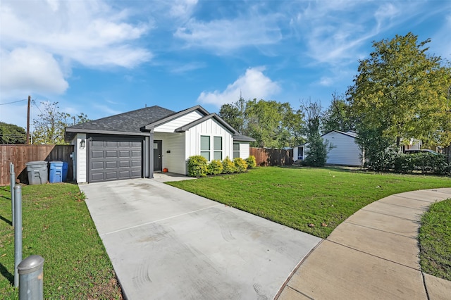 ranch-style house featuring a front yard and a garage