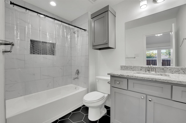 full bathroom with shower / bath combo, vanity, toilet, and tile patterned floors