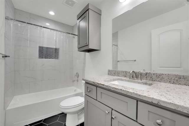 full bathroom featuring tile patterned floors, shower / tub combo with curtain, vanity, and toilet