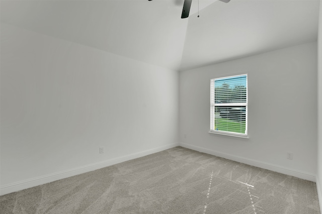 spare room featuring ceiling fan, lofted ceiling, and light colored carpet