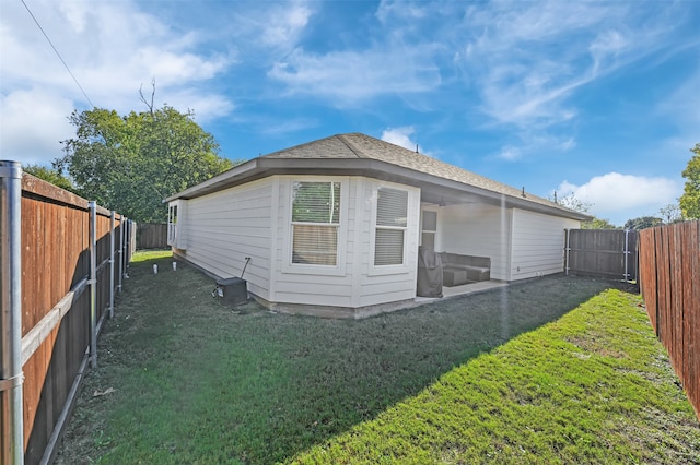 rear view of house featuring a yard