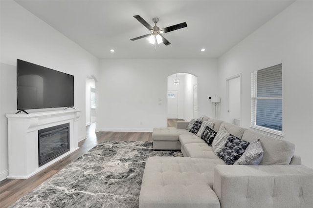 living room with ceiling fan and dark hardwood / wood-style floors