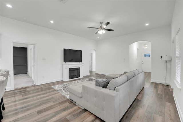 living room with ceiling fan and light hardwood / wood-style floors