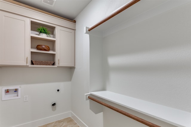 washroom with light tile patterned floors, hookup for an electric dryer, cabinets, and washer hookup