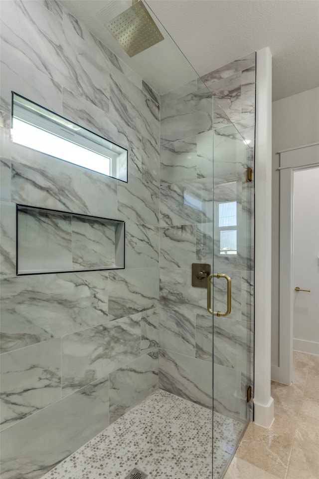 bathroom featuring a shower with shower door