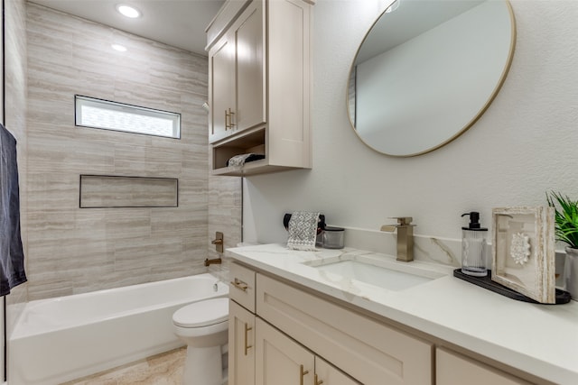 full bathroom with vanity, toilet, and tiled shower / bath