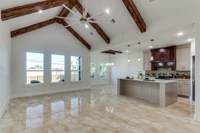 kitchen featuring beamed ceiling, high vaulted ceiling, a large island with sink, decorative light fixtures, and stainless steel range with electric cooktop