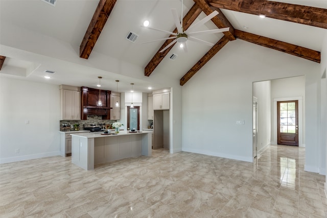 kitchen with hanging light fixtures, tasteful backsplash, high vaulted ceiling, beamed ceiling, and a center island with sink