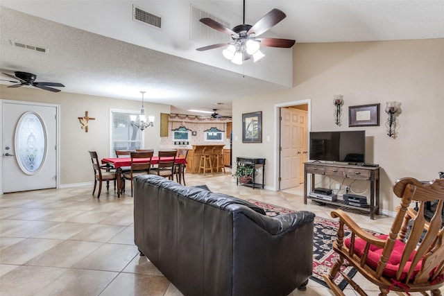 1491 County Road 456, Princeton, TX 75407 - tiled living room featuring ceiling fan with notable chandelier, a textured ceiling, and lofted ceiling