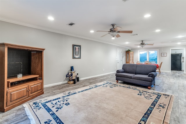 living room featuring crown molding, ceiling fan, and hardwood / wood-style flooring