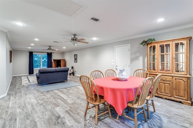 dining space with ornamental molding, ceiling fan, and light wood-type flooring