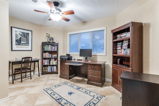 tiled home office featuring ceiling fan and a textured ceiling