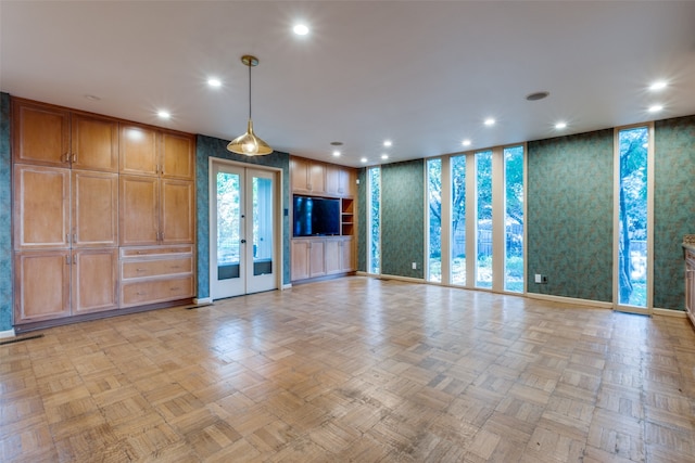 unfurnished living room with french doors and light parquet floors