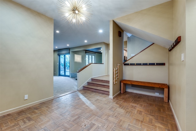 staircase featuring parquet floors and a notable chandelier